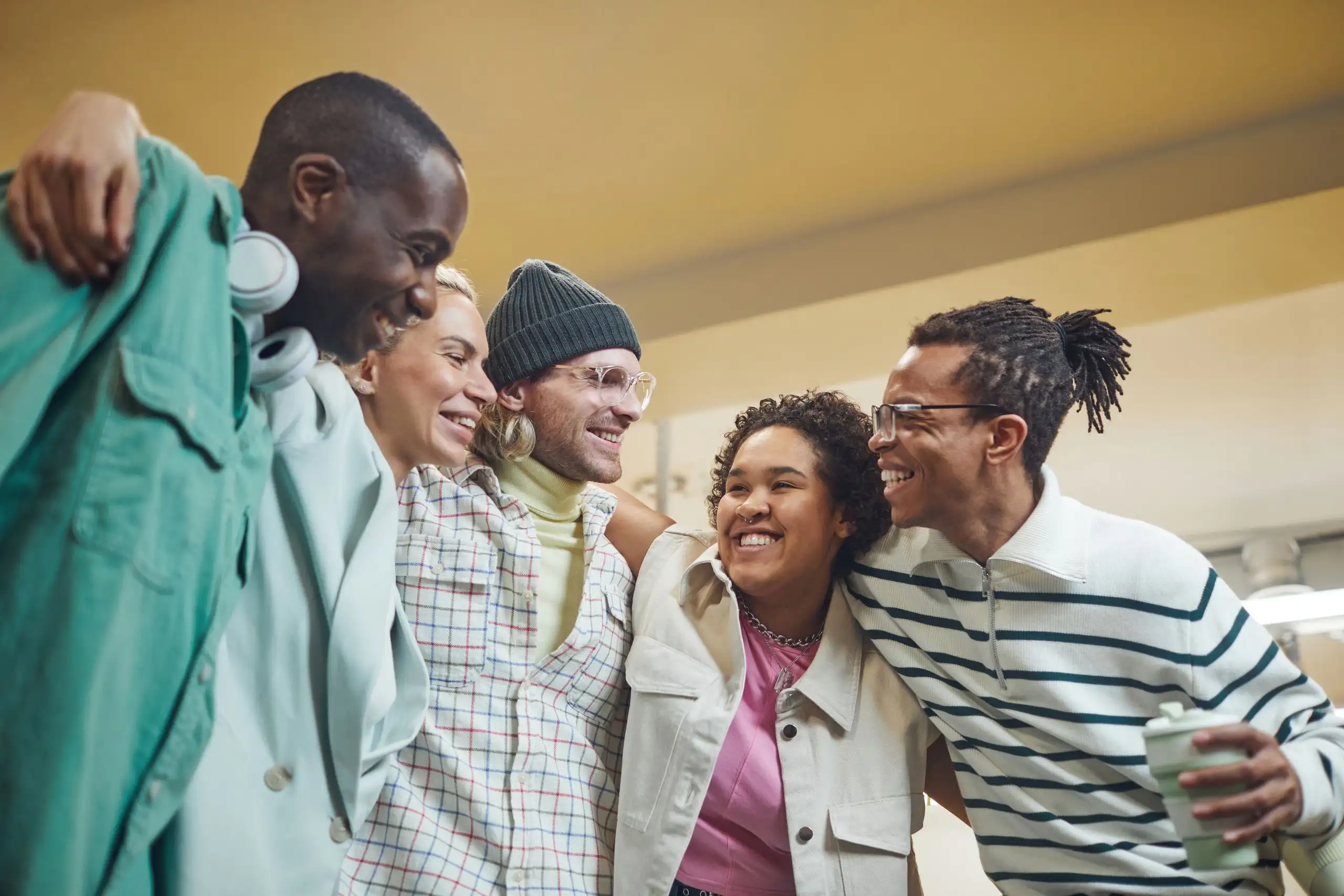 A small group of colleagues laughing together indoors